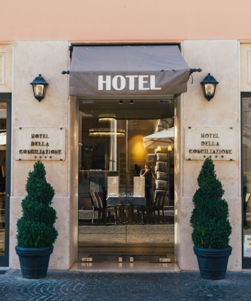 A photo of a boutique hotel with trees